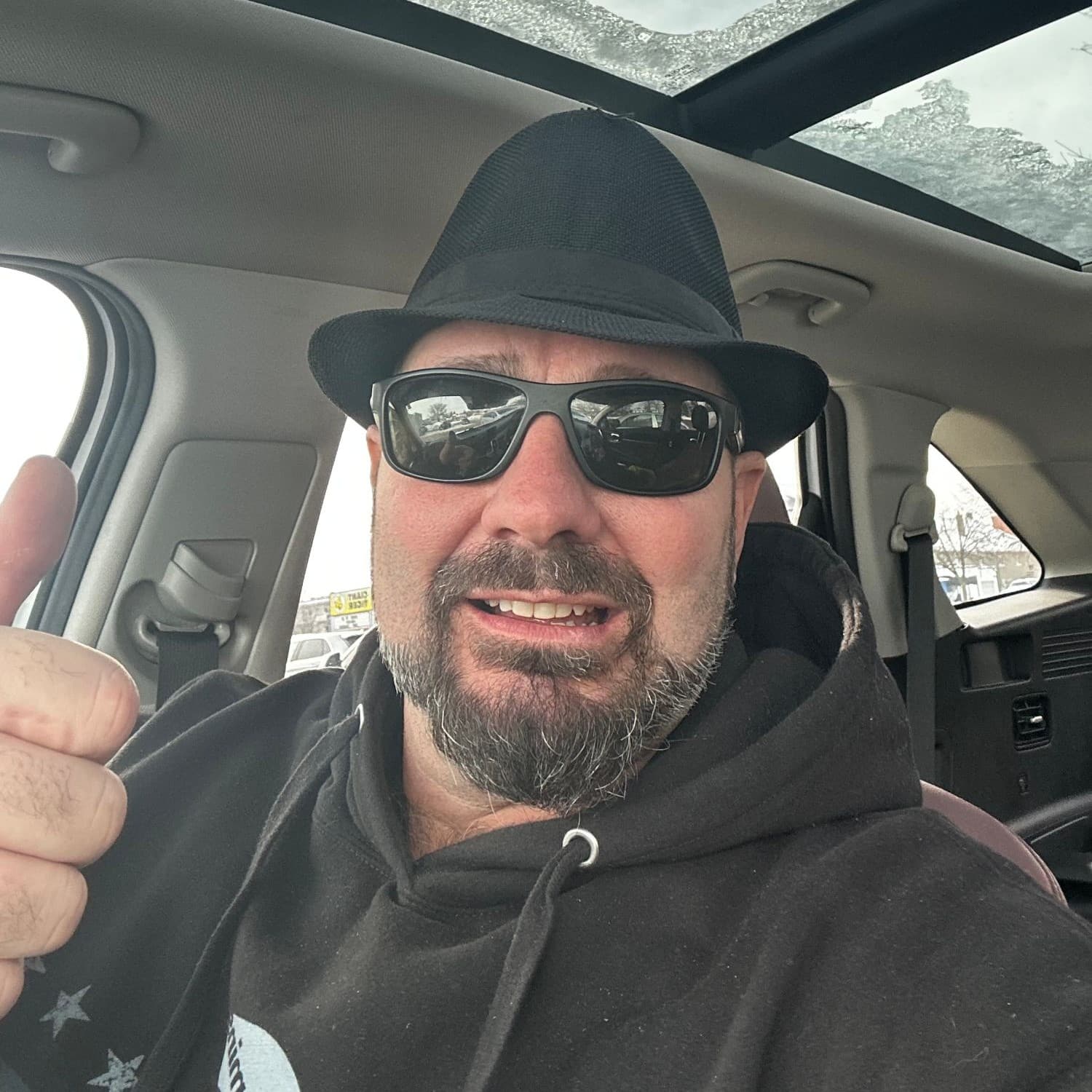 Christopher Schaub, owner of OnTec Innovations Inc., giving a thumbs-up from the driver's seat
